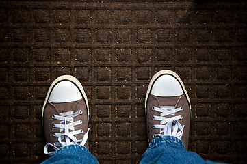 Image showing looking down at dirty door mat