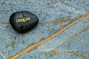 Image showing Black Imagine rock on blue soapstone