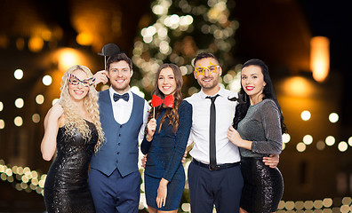 Image showing happy friends with party props posing