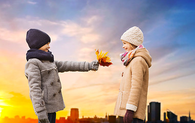 Image showing kids with autumn leaves over tallinn city sunset