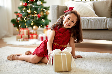 Image showing happy girl with christmas gift at home