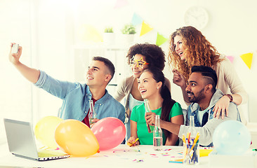 Image showing happy team taking selfie at office party