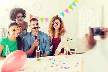 Image showing friends or team photographing at office party