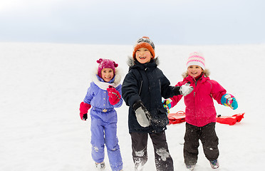 Image showing happy little kids playing outdoors in winter