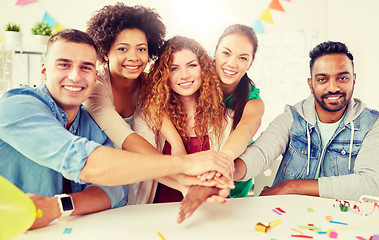 Image showing happy business team at office party holding hands