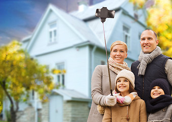 Image showing family takes autumn selfie by cellphone over house