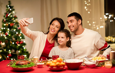 Image showing happy family taking selfie at christmas dinner