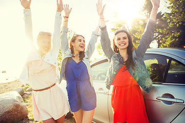 Image showing happy teenage girls or women near car at seaside