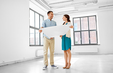 Image showing happy couple with blueprint at new home