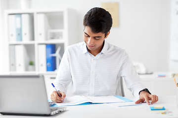 Image showing businessman working with papers at office