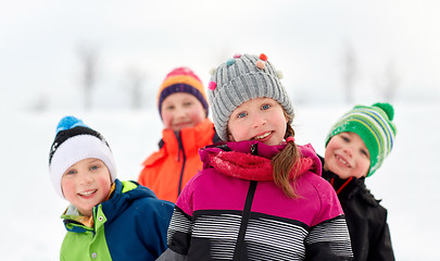 Image showing happy little kids in winter clothes outdoors