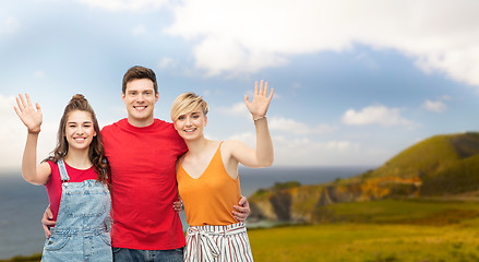 Image showing happy friends hugging over background