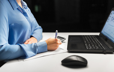 Image showing businesswoman with papers working at night office