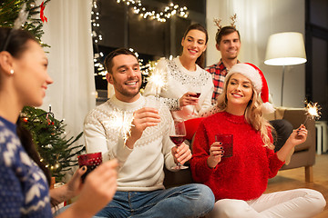 Image showing friends celebrating christmas and drinking wine