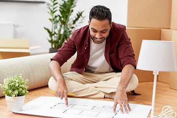 Image showing man with boxes and blueprint moving to new home