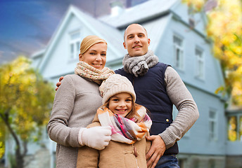 Image showing happy family over living house in autumn