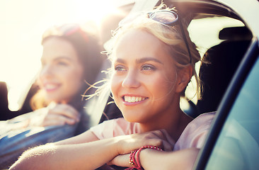 Image showing happy teenage girls or women in car at seaside