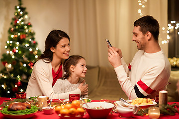 Image showing happy family taking picture at christmas dinner