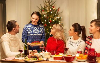 Image showing happy friends having christmas dinner at home