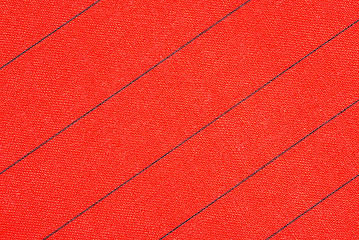 Image showing Abstract red fabric with black stripes texture background. Book cover.