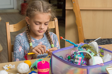 Image showing Girl crochets in a classroom at school