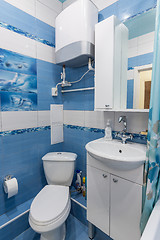 Image showing Interior of a small bathroom, toilet, wash basin, boiler