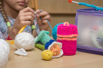 Image showing Childrens crafts-embroidery lying on the table, in the background the girl knits