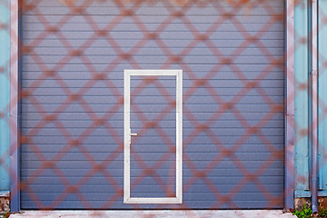 Image showing Dark grey doors of industrial warehouse for vehicles.