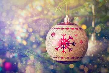 Image showing Christmas-tree decoration bauble on decorated Christmas tree bac