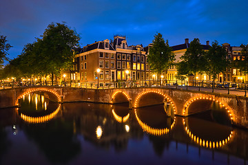 Image showing Amterdam canal, bridge and medieval houses in the evening