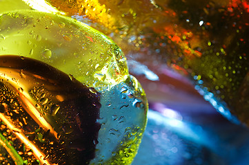 Image showing Bright colorful abstract background. Glass and drops of water.