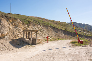 Image showing Mountain road, abandoned barrier and security booth