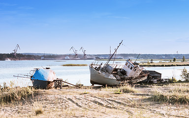 Image showing Old Abandoned Ships On The Riverbank Against A River Port 