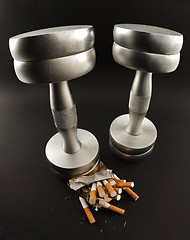 Image showing cigarettes crushed Dumbbell