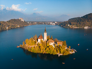 Image showing Aerial view of Bled island on lake Bled, and Bled castle and mountains in background, Slovenia.