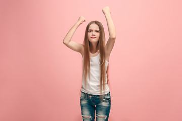 Image showing Portrait of angry teen girl on a pink studio background