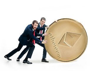 Image showing Two business men holding business icon