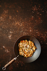 Image showing Traditional orginal fried spicy rice with chicken served in a round iron wok