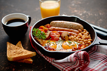 Image showing Full English breakfast on dark rusty background