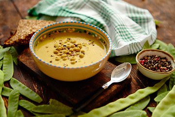 Image showing Green pea cream soup in grey bowl