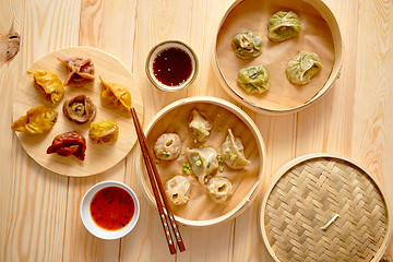 Image showing Traditional chinese dumplings served in the wooden bamboo steamer