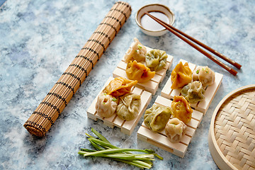 Image showing Delicious mixed kinds of chinese dumplings served on wooden stands