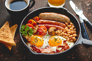 Image showing Full English breakfast on dark rusty background