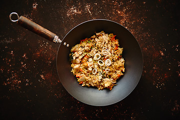 Image showing Traditional orginal fried spicy rice with chicken served in a round iron wok