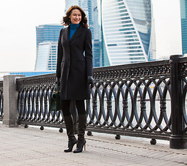 Image showing Smiling beautiful business woman in a dark coat