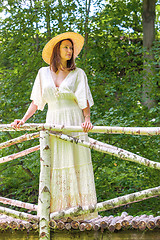 Image showing beautiful woman in summer hat and white dress