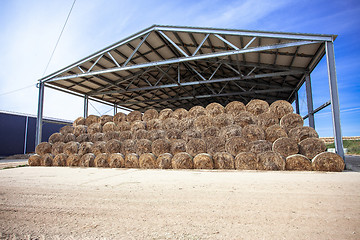 Image showing sloping hay under a canopy. 