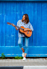 Image showing Beautiful middle aged woman with a guitar