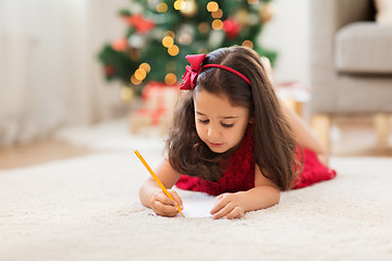 Image showing little girl writing christmas wish list at home