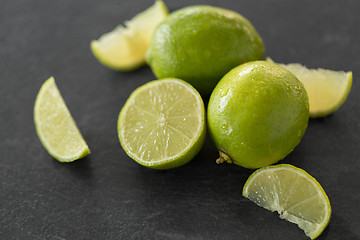 Image showing close up of limes on slate table top